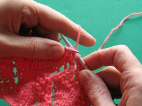 Place left hand needle back through both those stitches and knit together